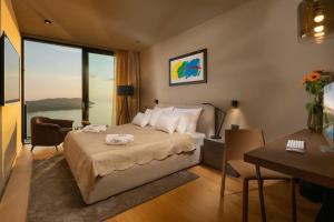 a hotel room with a bed with a view of the water at Frida's Villa in Dubrovnik +34 photos