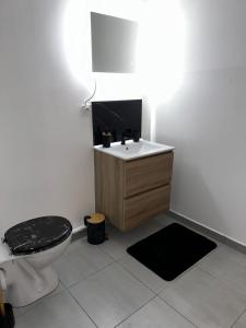 a bathroom with a toilet and a sink at Au cœur du nouveau cergy Aren park in Cergy