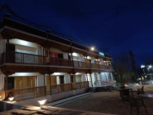 a building with lights on the side of it at night at Apricuss hotel in Leh