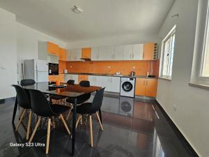 a kitchen with a table and chairs in it at RESIDENCIAL EUNICE in Praia
