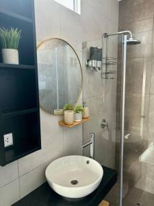 a bathroom with a sink and a mirror and a shower at Lindo Apart en Barranco cerca a Miraflores con BICICLETAS GRATIS in Lima +24 photos