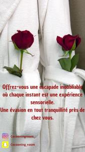 two red roses sitting on a white towel with text at Au cœur du nouveau cergy Aren park in Cergy