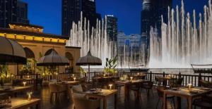 a restaurant with a fountain in the middle of a city at Luxury Studio, 29 Boulevard Burj Khalifa Downtown - Chalet Homes in Dubai