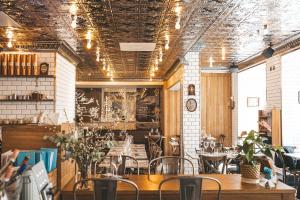 a restaurant with tables and chairs in a room at Hotel Klaus K in Helsinki