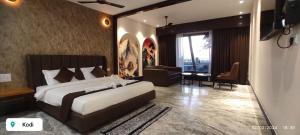a bedroom with a large bed and a living room at Nautical 9 Beach Retreat in Kundapur