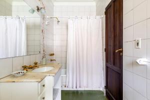 baño con lavabo y cortina de ducha en Casa Noble en Mendoza