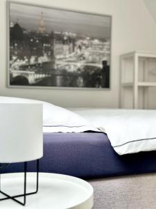 a bedroom with a bed and a table and a chair at Heide Apartments in Schneverdingen