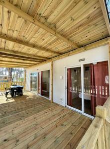 a large wooden deck with a ping pong table at Camping Village Mare Pineta in Paestum