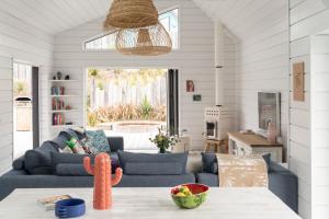 a living room with a couch and a table at Three Mile Beach in Hayle