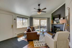 a living room with two chairs and a fireplace at Cozy La Veta Condo Walk to Cuchara Mountain Park! in La Veta