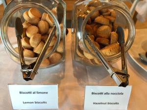 two glass containers filled with food on a table at Agriturismo Demarie in Vezza d'Alba