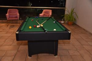 a pool table with balls on it in a room at Jaiswal Valley in Aurangabad