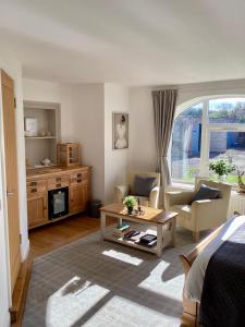a living room with a couch and a table at The Garden rooms in Bedale
