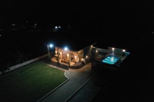 a house with a swimming pool at night at Jaiswal Valley in Aurangabad