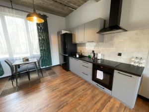 a kitchen with a sink and a table in it at Barwny Zakątek in Augustów