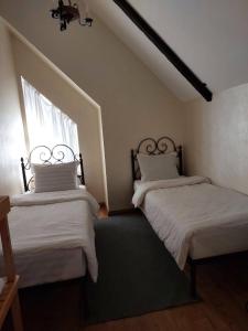 a bedroom with two beds and a window at Villa Hills in Chimgan +12 photos