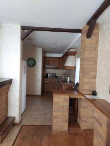 a kitchen with a counter and a brick wall at Villa Hills in Chimgan