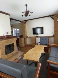 a living room with a fireplace and a tv at Villa Hills in Chimgan