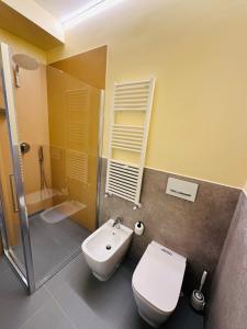 ein Badezimmer mit einem weißen WC und einem Waschbecken in der Unterkunft Nuovo appartamento Castiglione in Castiglione della Pescaia
