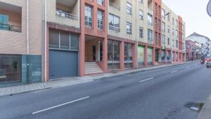 an empty street in a city with buildings at Vale Formoso Guest House in Porto