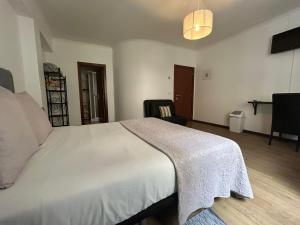 Postel nebo postele na pokoji v ubytování Palmar Rooms