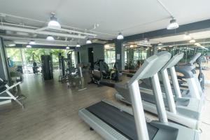 a gym with treadmills and machines in a room at Condo I -House Laguna Garden RCA - Outer CBD in Bangkok