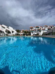 a large swimming pool in front of some buildings at The Best House Tenerife Habitaciones Compartidas in Adeje