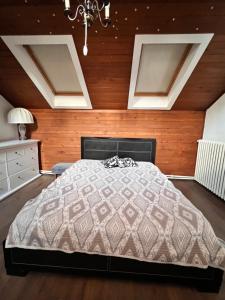 a bedroom with a bed and wooden walls at Belgrade View Senjak in Senjak (historical)