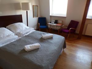 a hotel room with two towels on a bed at Open Doors Villa in Gdańsk
