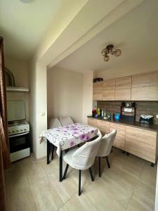 a kitchen with a table and chairs in a room at ПЕТРОВ 2 in Vratsa