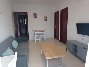 コニル・デ・ラ・フロンテーラにあるGlauka Apartamento tranquilo con Aire Acondicionadoのリビングルーム(ソファ、テーブル付)