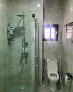 a bathroom with a toilet and a glass shower at 3 Bedroom Apartment in Lekki in Lekki
