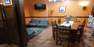 jadalnia ze stołem, krzesłami i telewizorem w obiekcie Villa y Corte - Castillo w mieście Ampudia