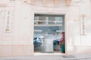 Giorgio Boutique Hotel في سليمة: نافذة مخزن فيها سيارة