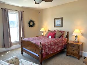 a bedroom with a bed and two lamps and a window at Lady Mary Angeline in Saint Ignace