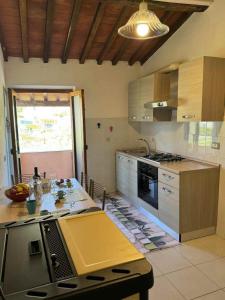 a kitchen with a sink and a stove top oven at Casa Peppo in Marciana