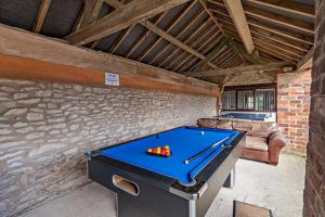 a pool table in a room with a couch at Goldfinch cottage in Newton