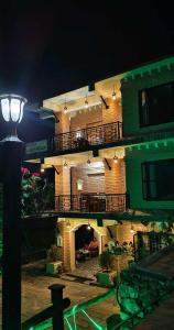 a large building with a balcony and a street light at Hotel Garangja in Bandipur