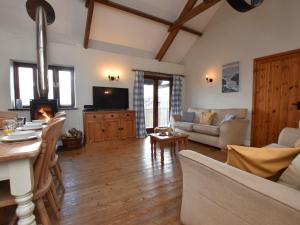 a living room with a couch and a table at 4 Bed in Bude CORYS in Morwenstow