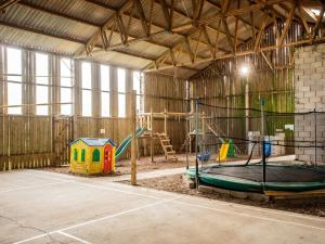 a large barn with a playground in it at 3 Bed in Bude CORYM in Morwenstow