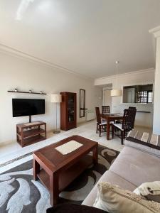 a living room with a couch and a table at Casa Del Sol by Rental Hero in San Javier