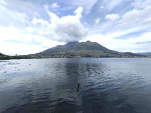 a mountain in the middle of a large body of water at Hotel Rosim Cotopaxi in Latacunga