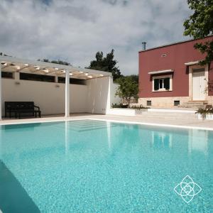 a swimming pool in front of a house at Villa Aurelia in Castellana Grotte