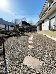 a stone path next to a building next to a building at アラン別邸自然溢れる呼人の一軒家 in Yobito