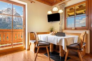 a dining room with a table with a laptop on it at Ronsolhof Santner in Siusi