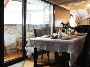 a dining room table with a white table cloth on it at B & B Da Lella in Trieste