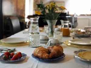 a table with strawberries and croissants on a table at B & B Da Lella in Trieste
