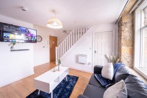 a living room with a couch and a table at 1 Bedroom Kirkstall Centre Apartment Ideal for Corporate Guests, Free Parking in Leeds