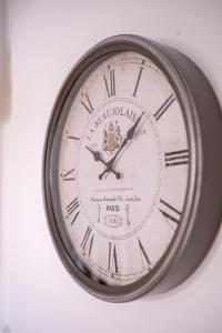 a clock that is on a wall at 1 Bedroom Kirkstall Centre Apartment Ideal for Corporate Guests, Free Parking in Leeds