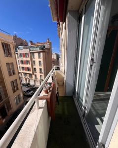 an apartment balcony with a view of a city at Appartement Cosy - Plein centre in Marseille